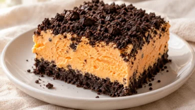 A frozen tray dessert layers a chocolate-cookie crust, orange sherbet and whipped cream.