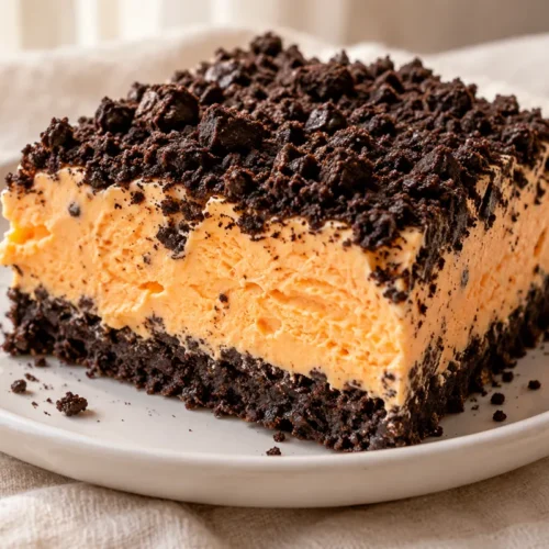 A frozen tray dessert layers a chocolate-cookie crust, orange sherbet and whipped cream.