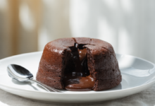 A delicious chocolate lava cake with a scoop of vanilla ice cream and a sprig of mint.