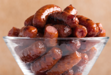 3-ingredient crockpot little smokies coated in barbecue sauce and grape jelly, served in a slow cooker with toothpicks.