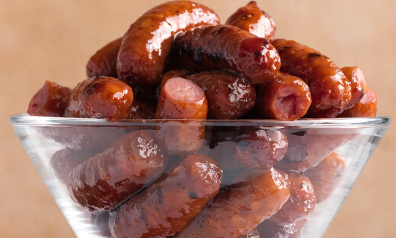 3-ingredient crockpot little smokies coated in barbecue sauce and grape jelly, served in a slow cooker with toothpicks.