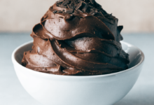 Fudge pieces arranged on a white serving plate, with some pieces scattered around for presentation. easy fudge recipe