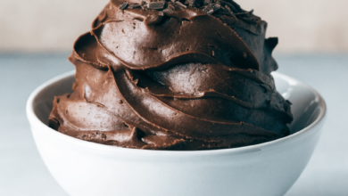 Fudge pieces arranged on a white serving plate, with some pieces scattered around for presentation. easy fudge recipe