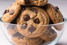 Close-up of a stack of peanut butter chocolate chip cookies on a wire rack.