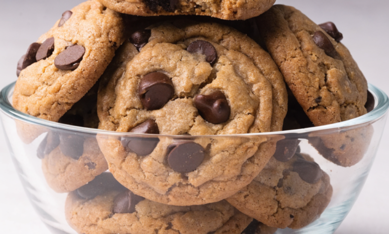 Close-up of a stack of peanut butter chocolate chip cookies on a wire rack.