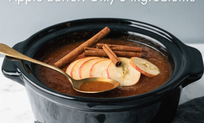 Thick, spiced slow cooker apple butter in a jar with fresh apples nearby, a featured homemade autumn recipe.