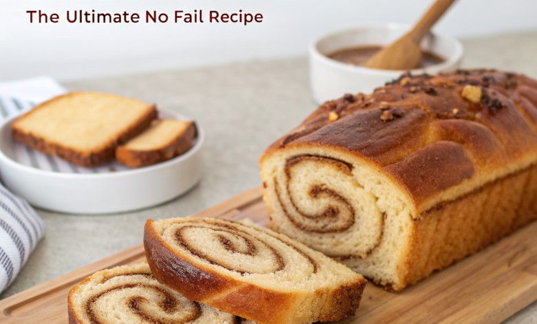 A slice of fluffy homemade cinnamon swirl bread shows a dark spice spiral and golden crust on a wooden board.